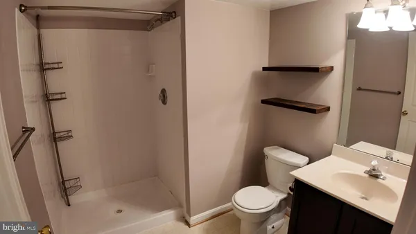 a white toilet sitting next to a bathroom sink