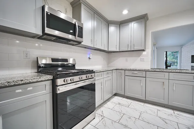 a kitchen with cabinets stainless steel appliances and cabinets