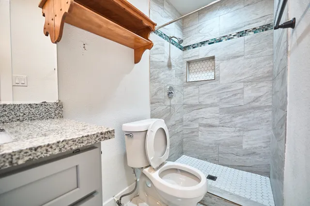 a white toilet sitting next to a bathroom sink