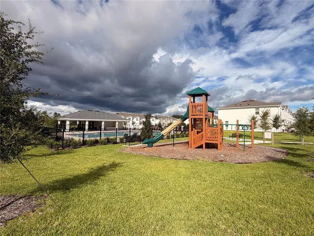 a view of a house with swimming pool and garden