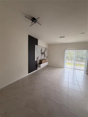 a view of an empty room with a window