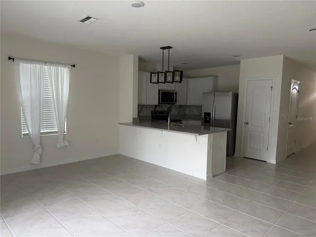 a kitchen with cabinets and window
