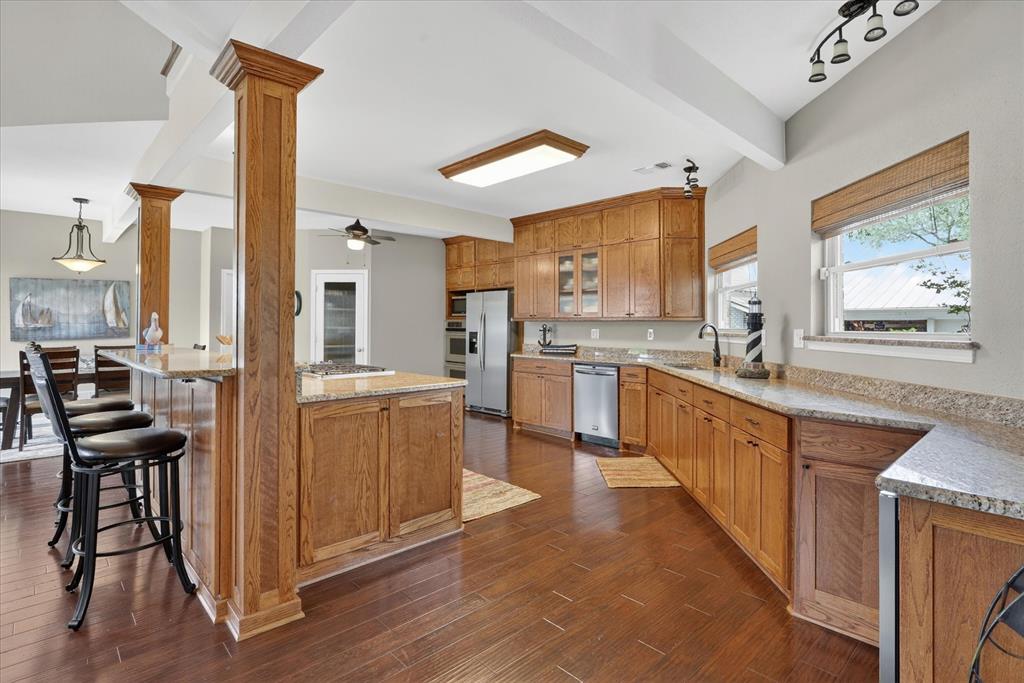 8877 Random Road Fort Worth, TX 76179 - Photo 7 of 40 a kitchen with sink cabinets and wooden floor