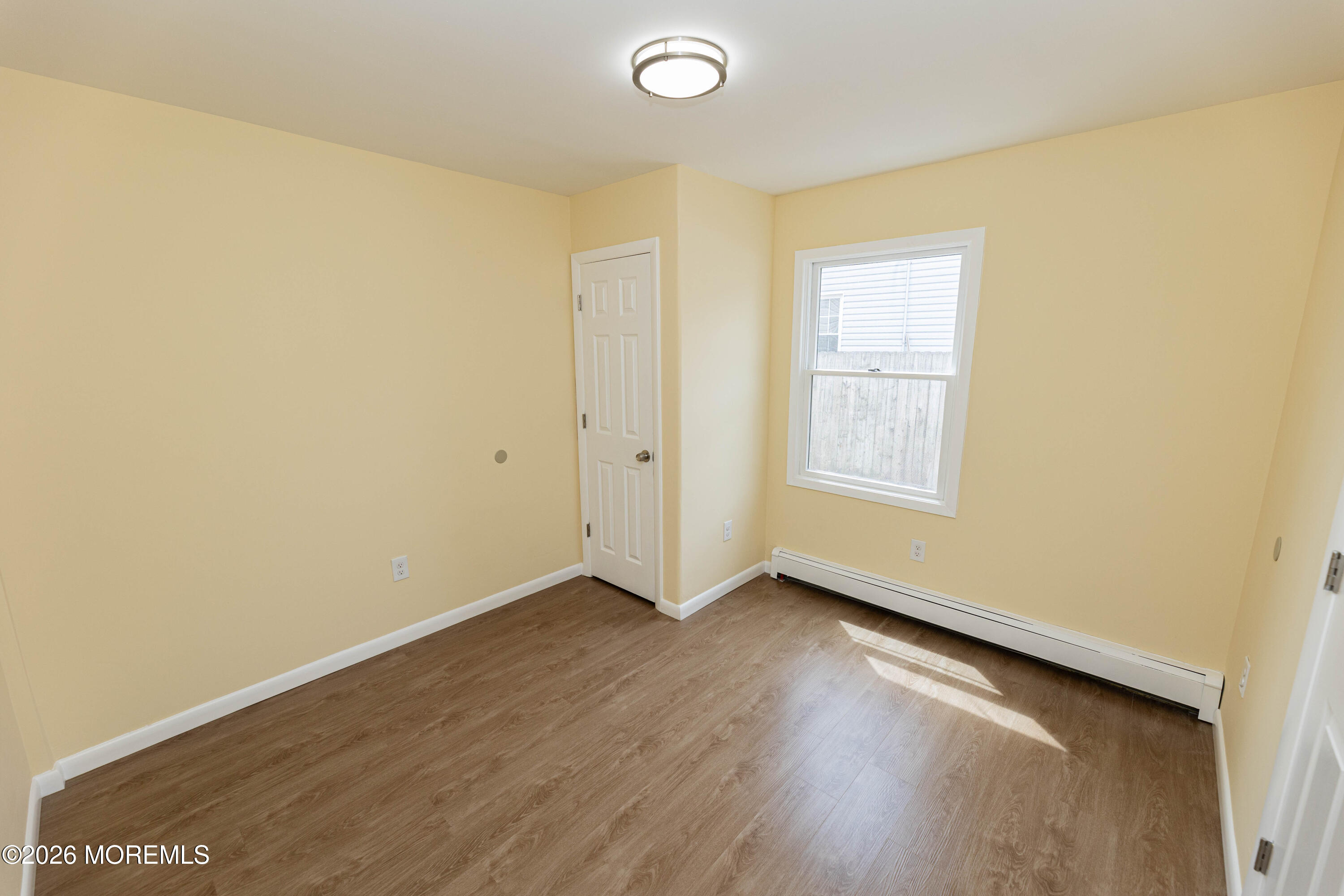 2408 Herbertsville Road Point Pleasant, NJ 08742 - Photo 50 of 82 an empty room with wooden floor and windows