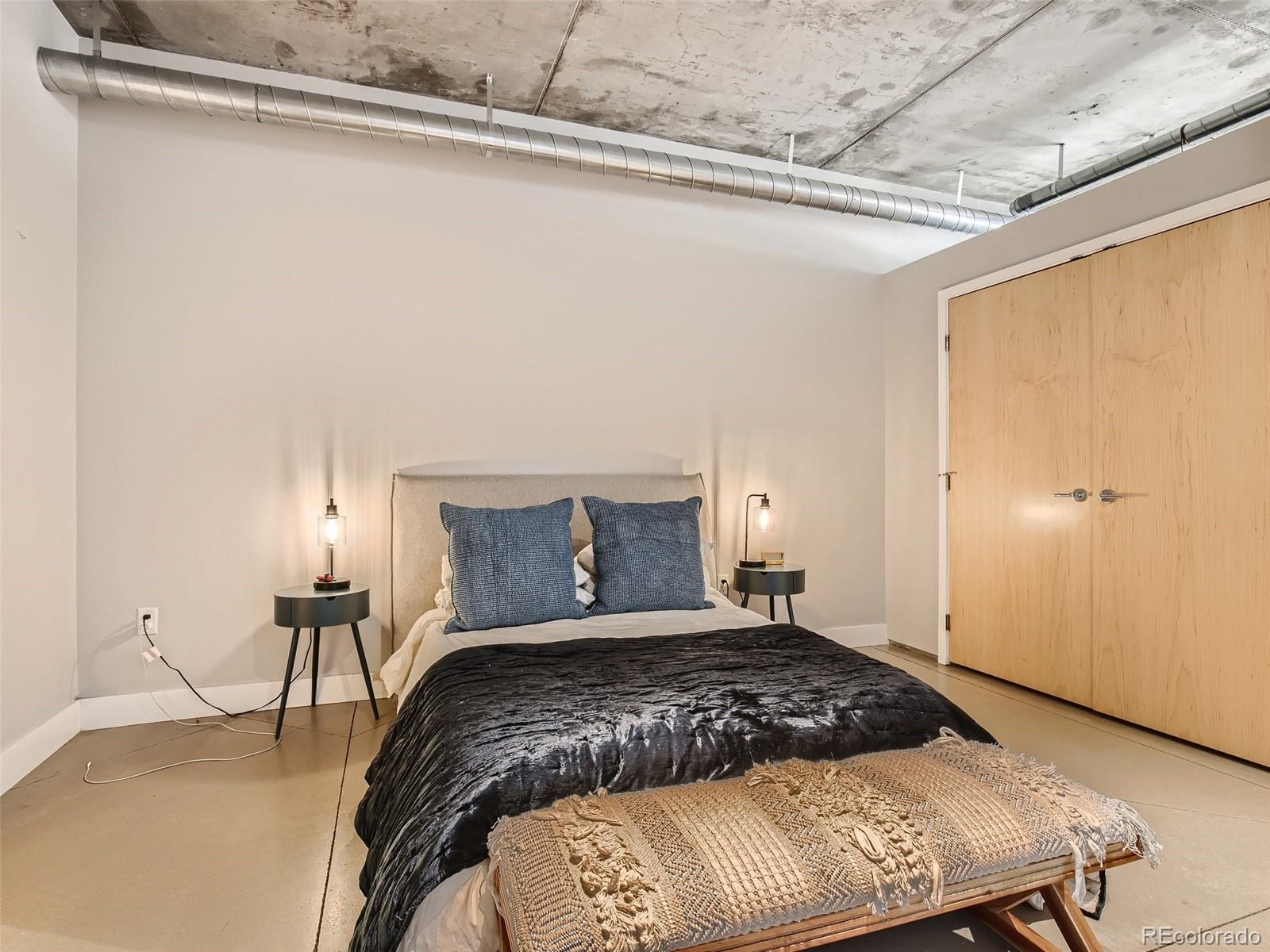 2100 16th St Mall, Unit 604 Denver, CO 80202 - Photo 11 of 20 a bedroom with a bed and a table