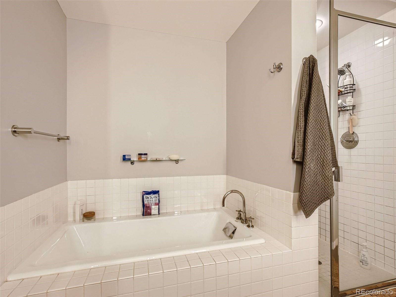 2100 16th St Mall, Unit 604 Denver, CO 80202 - Photo 16 of 20 a bathroom with a tub and a sink