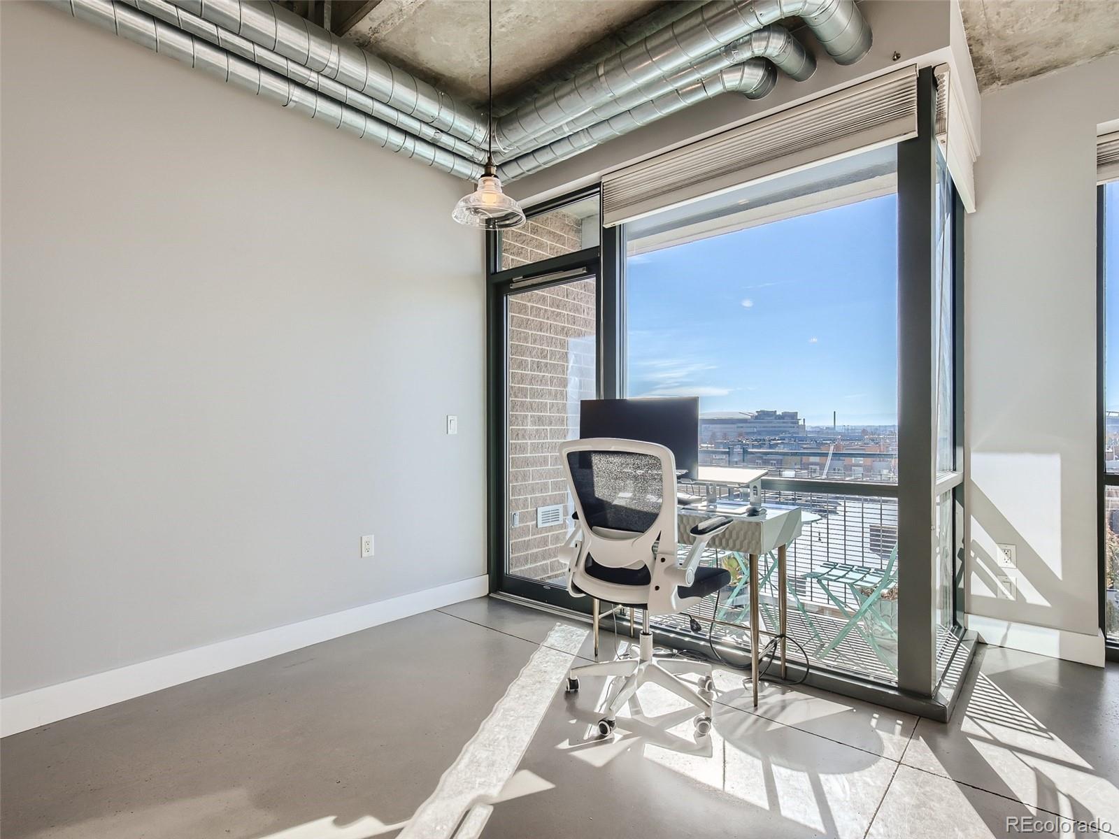 2100 16th St Mall, Unit 604 Denver, CO 80202 - Photo 10 of 20 a living room with a chair and couch