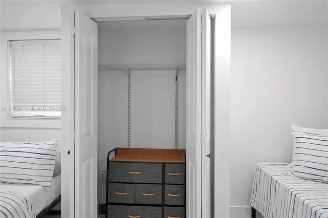 a view of room with closet and wooden floor