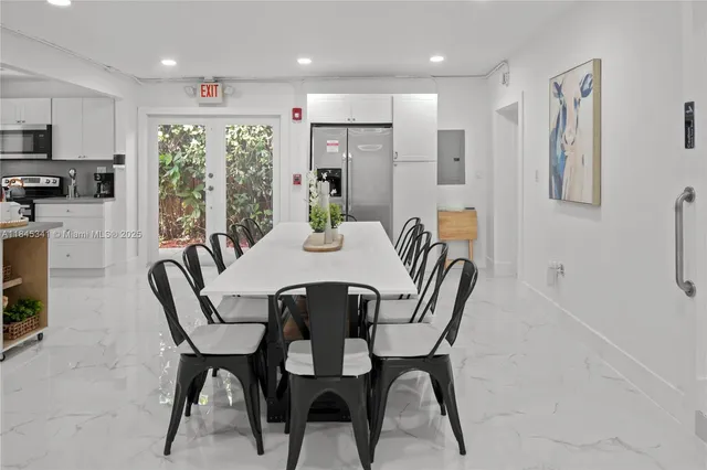 a dining room with furniture a window and kitchen view