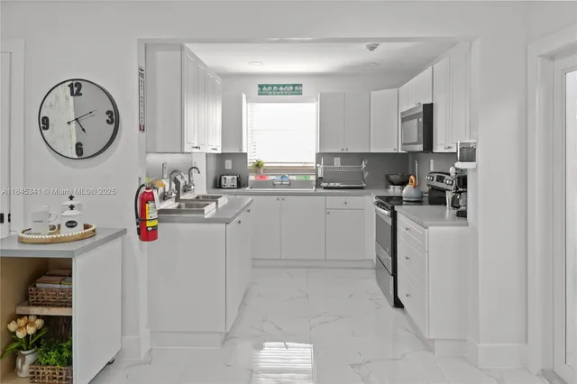 a kitchen with sink a window and cabinets