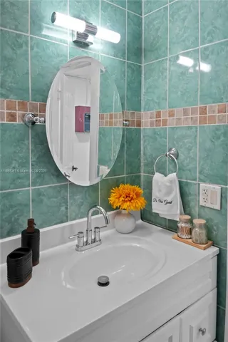 a bathroom with a shower curtain and sink