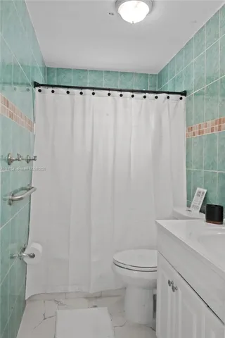 a bedroom with a bed and a lamp