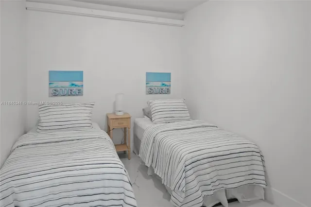 a view of a bedroom with a flat tv screen and a bed