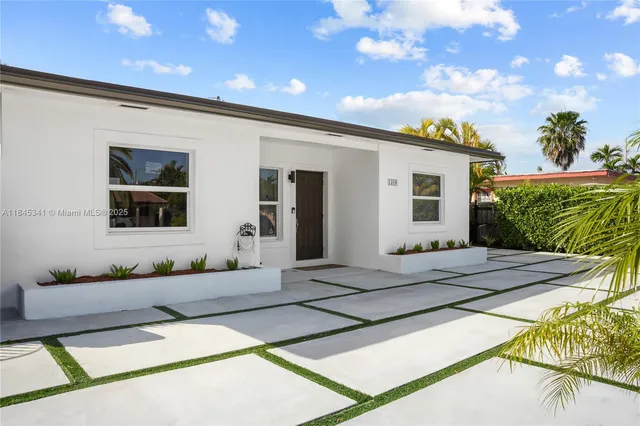 a front view of a house with a garden