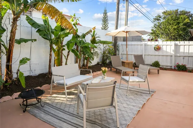 a view of a patio with table and chairs and potted plants
