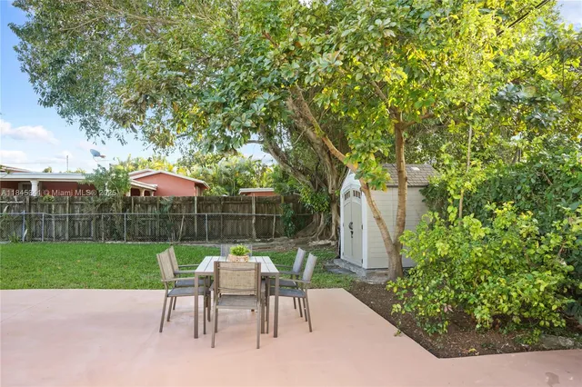 a view of a table and chairs under an umbrella
