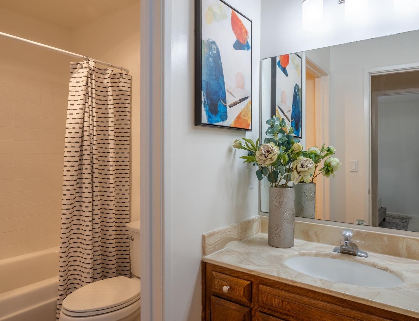 2040 West Middlefield Road, Unit 12 Mountain View, CA 94043 - Photo 11 of 24 a bathroom with a granite countertop sink and a mirror
