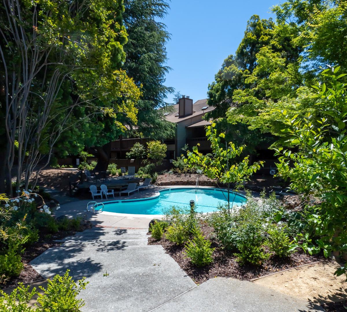 2040 West Middlefield Road, Unit 12 Mountain View, CA 94043 - Photo 21 of 24 a view of a garden with plants and large trees