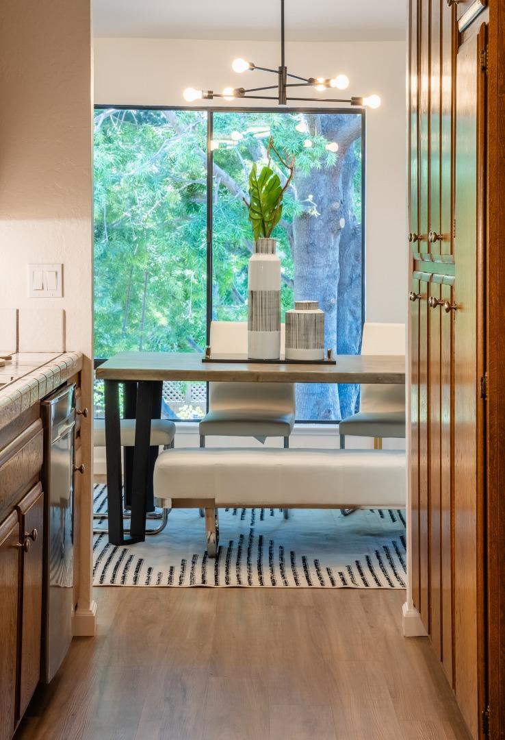 2040 West Middlefield Road, Unit 12 Mountain View, CA 94043 - Photo 7 of 24 a view of a balcony with a table and chairs