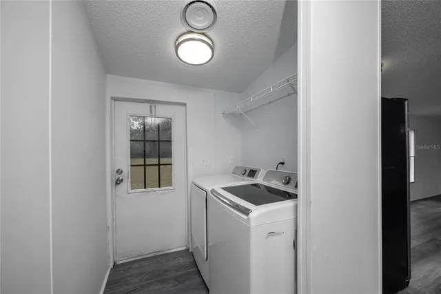 a utility room with sink dryer and washer