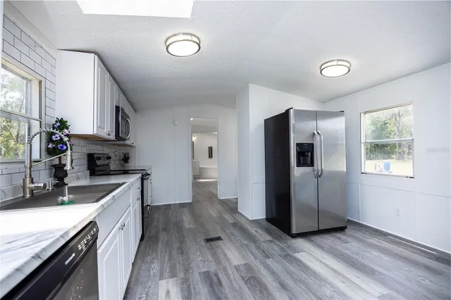 a kitchen with a refrigerator and a sink