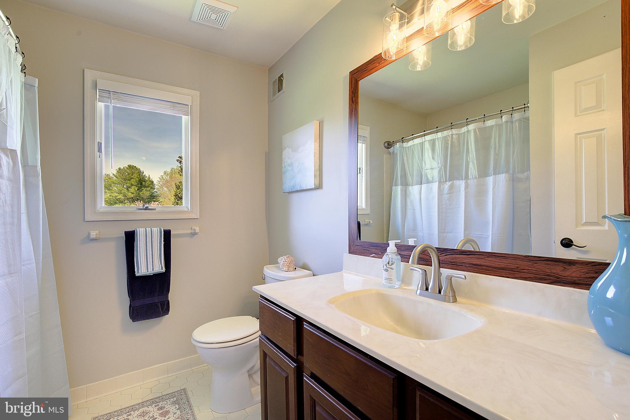 3050 Hickory Ridge Road Dunkirk, MD 20754 - Photo 19 of 78 a bathroom with a granite countertop sink toilet and mirror