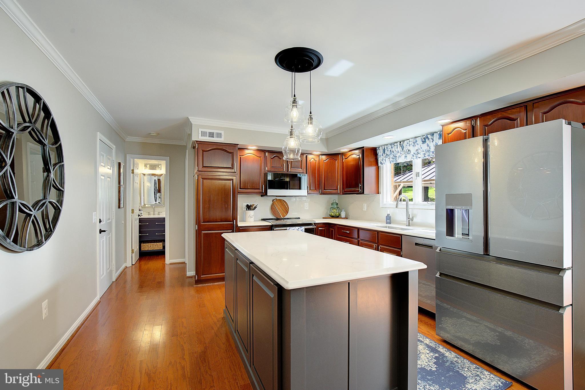 3050 Hickory Ridge Road Dunkirk, MD 20754 - Photo 37 of 78 a kitchen with stainless steel appliances a stove refrigerator and a wooden floor