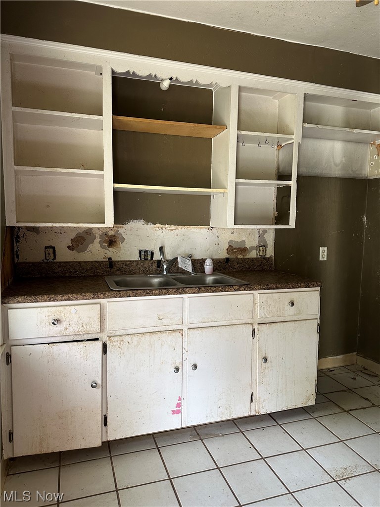 176 East Wilbeth Road Akron, OH 44301 - Photo 5 of 17 Kitchen featuring sink, light tile floors, and tasteful backsplash