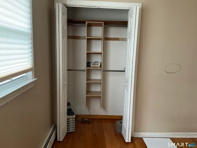 a room with a bench and a window