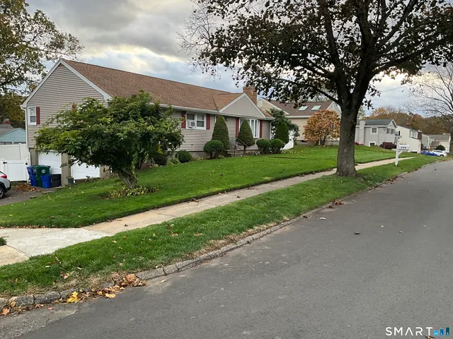 a front view of house with yard and green space
