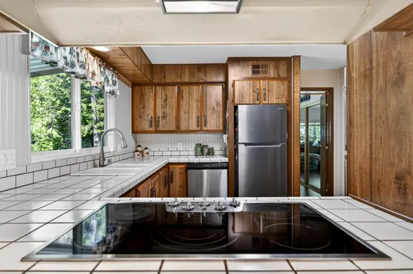 a kitchen with a sink and refrigerator