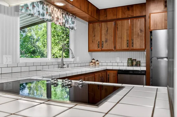 a kitchen with a cabinets a sink and a stove top oven