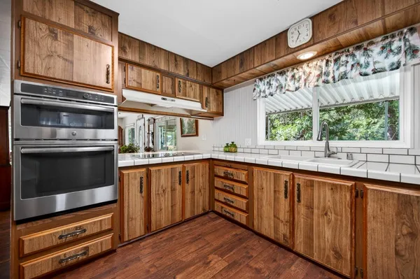 a kitchen with stainless steel appliances granite countertop a stove and a sink