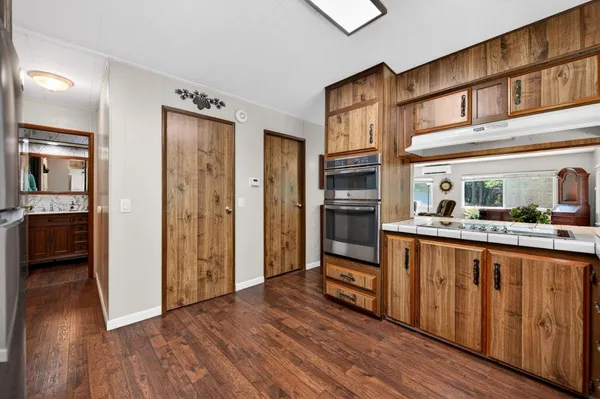 a kitchen with stainless steel appliances granite countertop a refrigerator and a sink