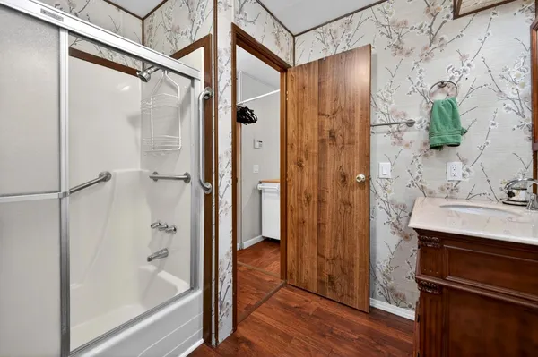 a bathroom with a shower and a sink