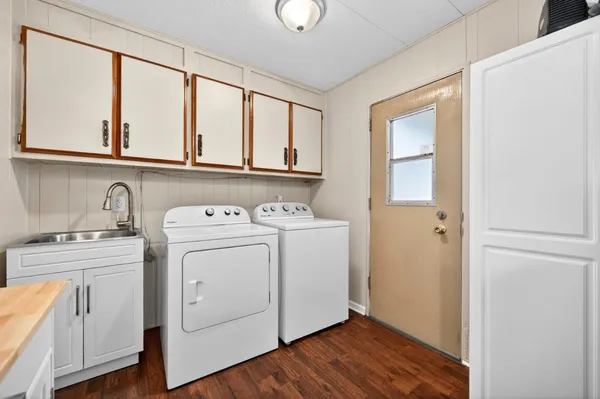 a view of washer and dryer with kitchen view