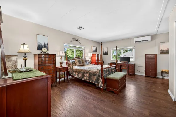 a bedroom with a bed window and a couch