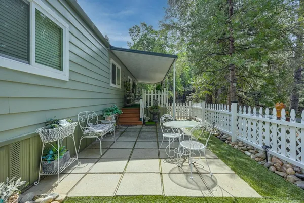 a view of a chairs and table in backyard
