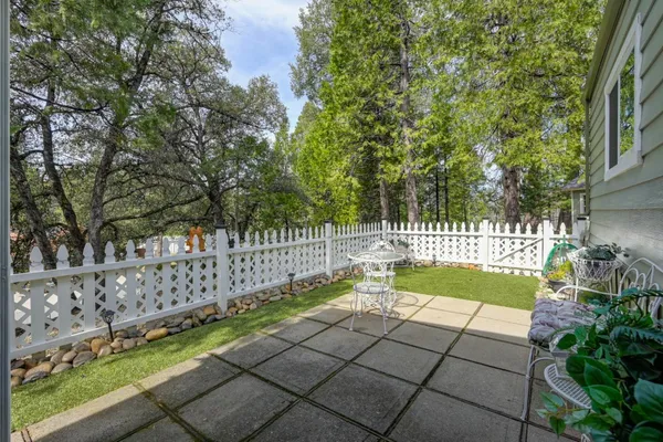 a view of garden with wooden fence