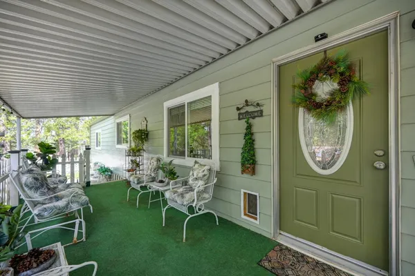a view of an chairs and table in patio