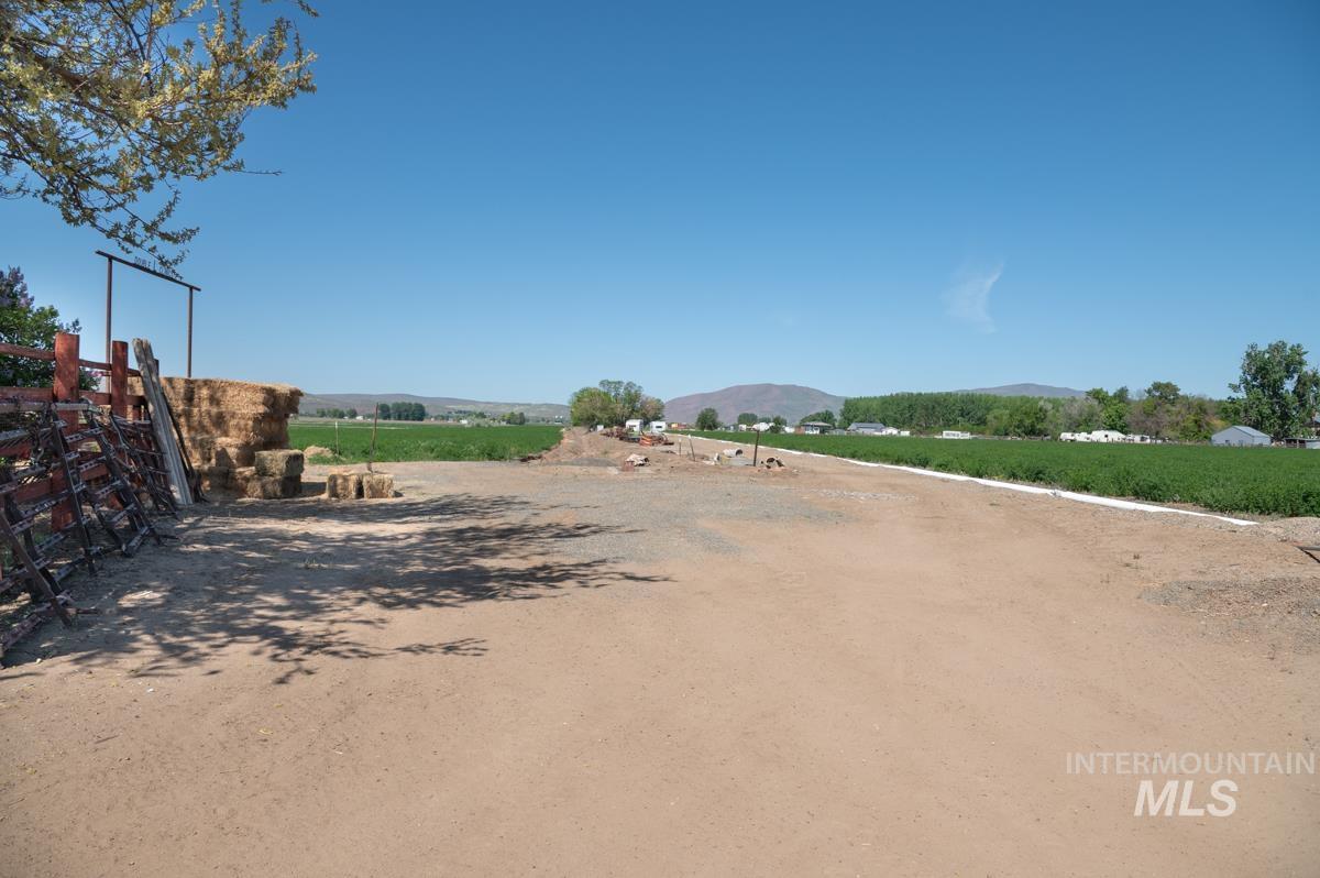 733 Pringle Road Weiser, ID 83672 - Photo 39 of 46 View of dirt / gravel road featuring a view of countryside, agricultural plots, and a mountain view