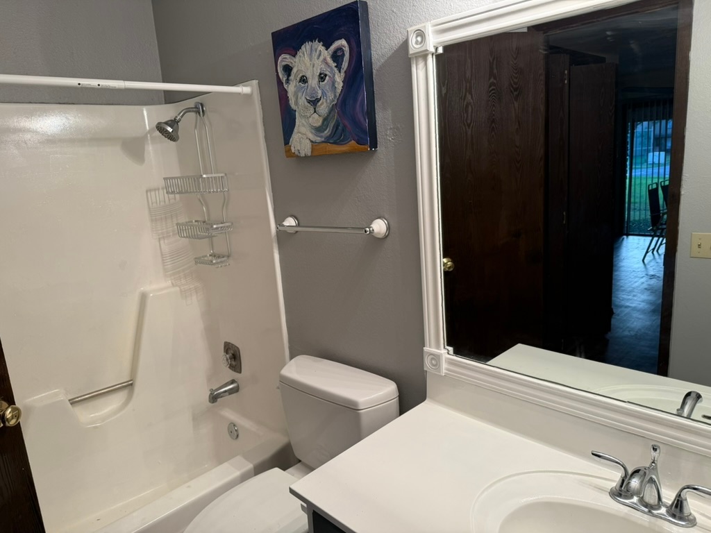 907 East Meadowmere Lane Austin, TX 78758 - Photo 11 of 23 a bathroom with a toilet and a shower