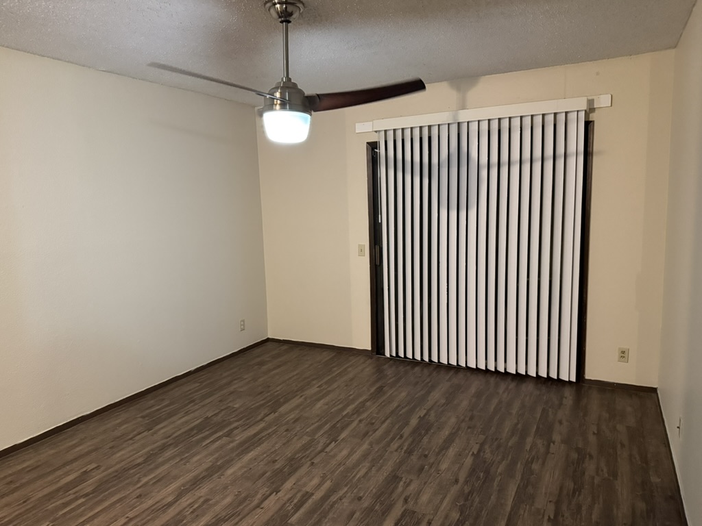 907 East Meadowmere Lane Austin, TX 78758 - Photo 15 of 23 a view of a livingroom with wooden floor and a ceiling fan