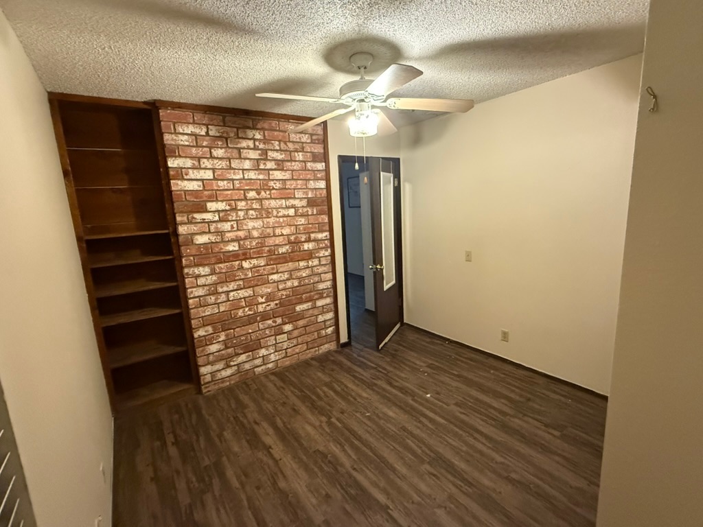 907 East Meadowmere Lane Austin, TX 78758 - Photo 20 of 23 a view of empty room with wooden floor and fan