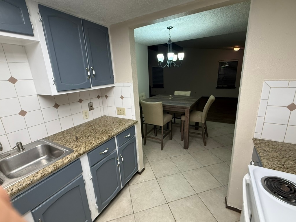 907 East Meadowmere Lane Austin, TX 78758 - Photo 2 of 23 a kitchen with stainless steel appliances granite countertop a sink and a stove