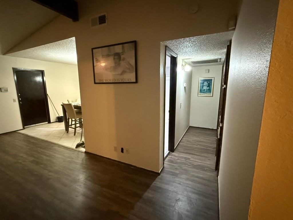 907 East Meadowmere Lane Austin, TX 78758 - Photo 10 of 23 a view of a hallway with wooden floor