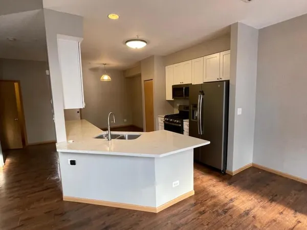 a kitchen with stainless steel appliances a refrigerator and a stove