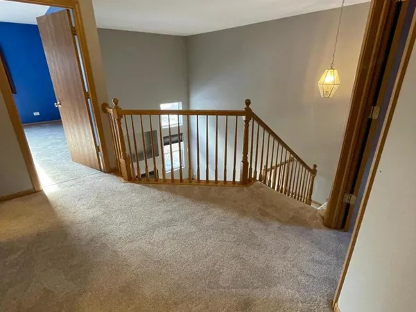 a view of a hallway with a stairs