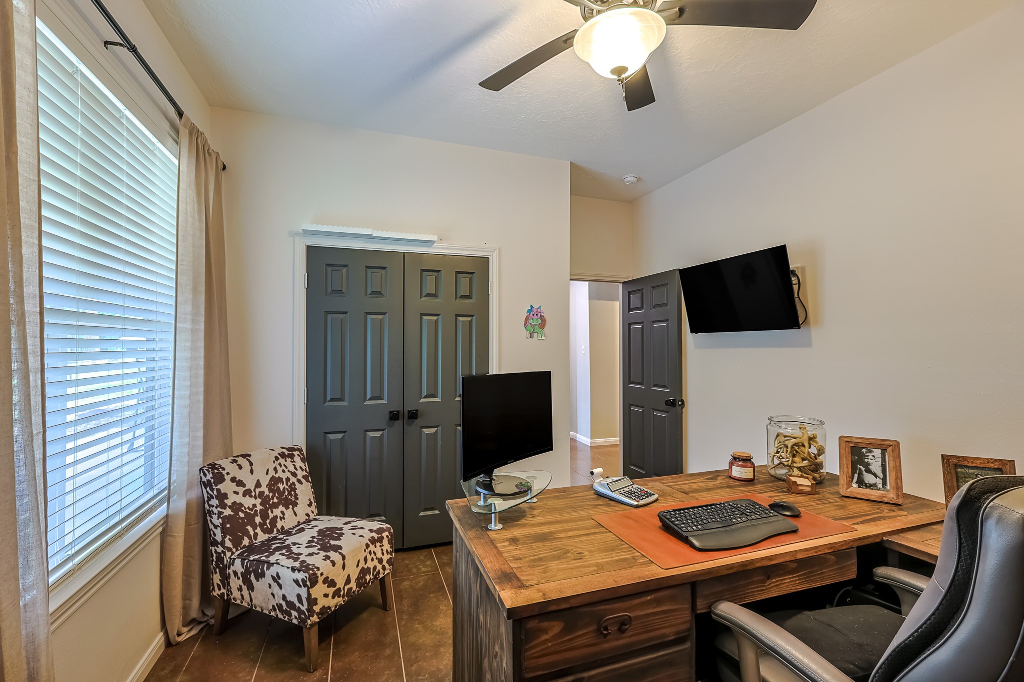 6409 Medley Road New Waverly, TX 77358 - Photo 27 of 50 Secondary bedroom currently being used as an office with a large window overlooking the pond, double door closet, high ceiling and stained concrete floors.