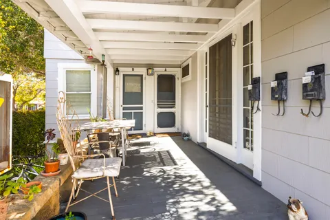 a view of a patio with table and chairs and potted plants